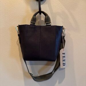 NWT. FEED leather bucket bag. classic black, top handles adjustable crossbody.